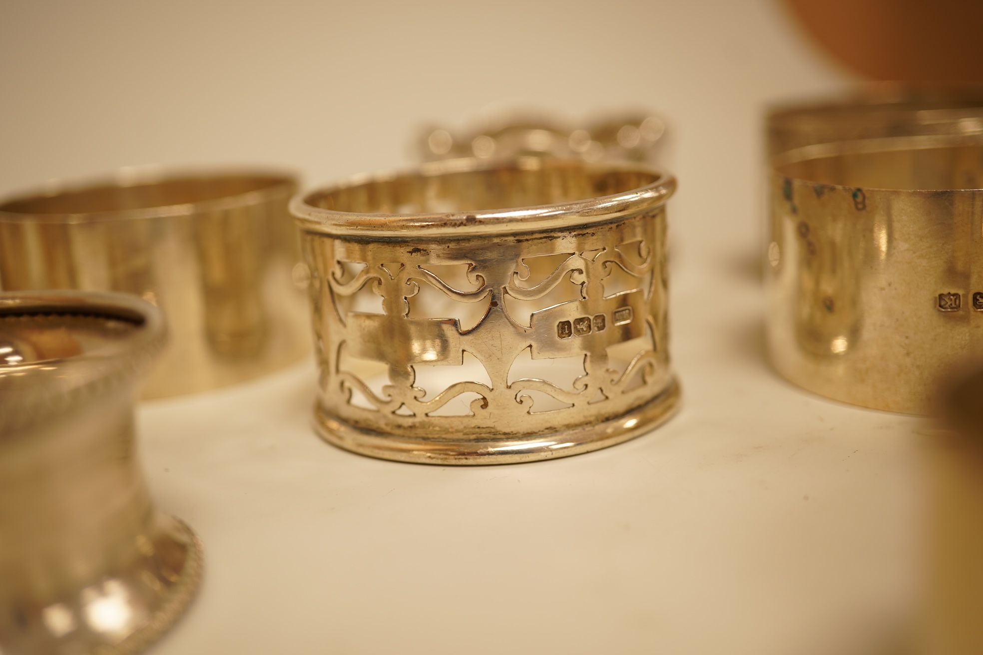 A pair of Edwardian pieced silver napkin rings by Henry Wigfull, Sheffield, 1905, together with nine other assorted silver napkin rings.